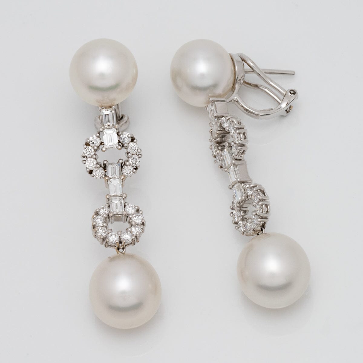 Assael Collection: 10.8-12.7 mm White South Sea Pearl and Diamond Dangle Earrings featuring two lustrous white pearls connected by intricate diamond-set links in a refined drop design.