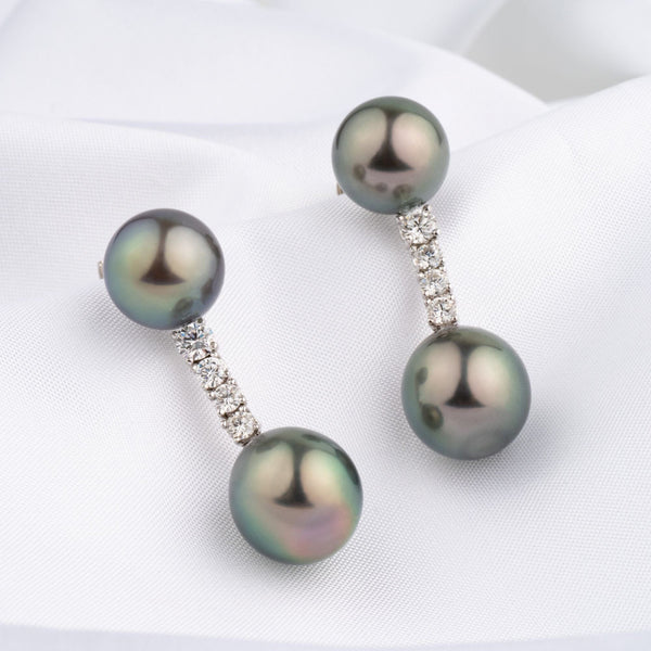 Assael Collection: 10.4–11.2 mm Tahitian Pearl and Diamond Earrings featuring lustrous black Tahitian pearls connected by a vertical row of sparkling diamonds on a white fabric background.
