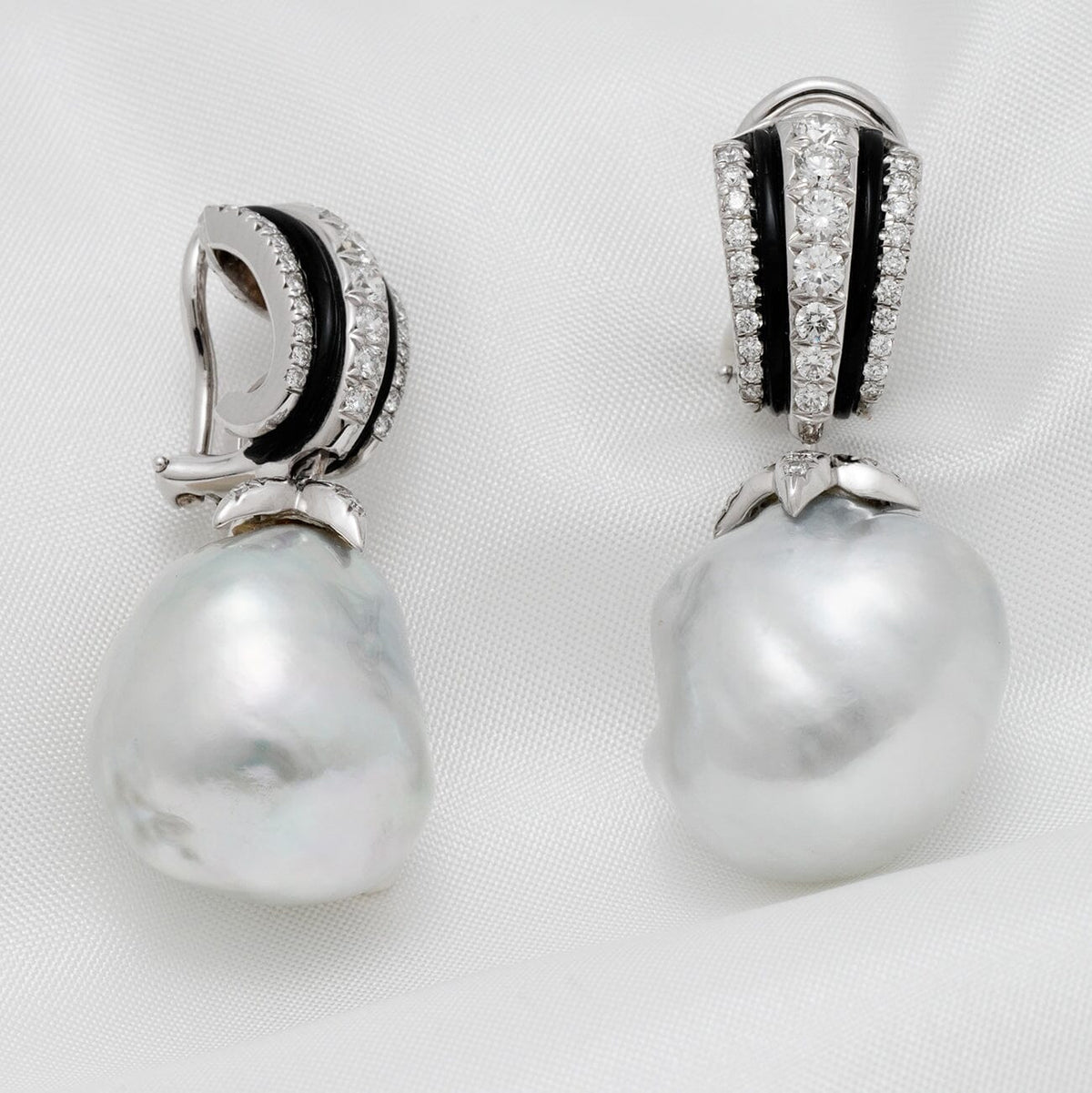 Assael Collection: 17.2 by 18.1 mm South Sea Pearl and Diamond Earrings featuring large white pearls with diamond and black enamel accents on a 14K white gold setting.