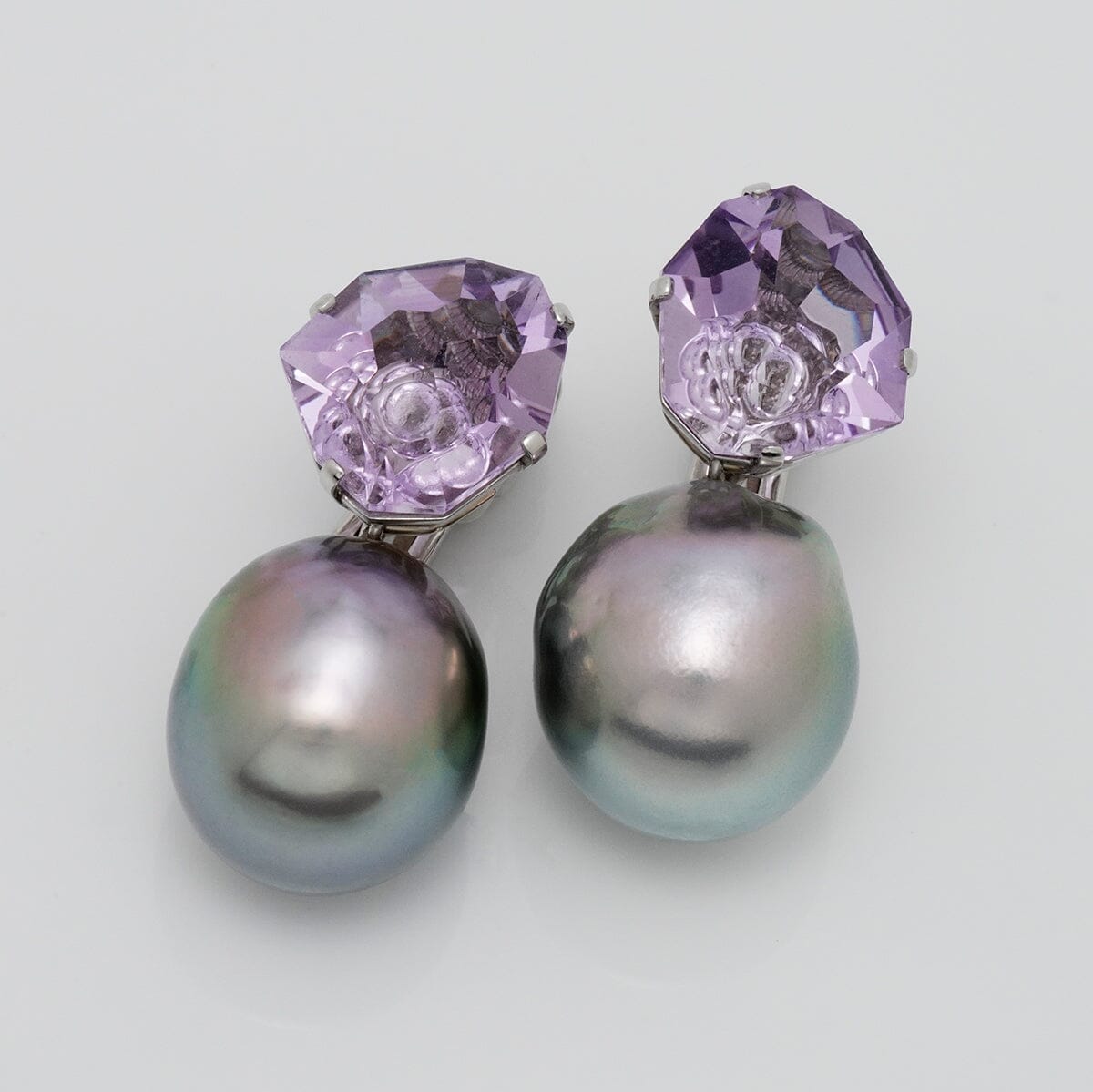 Assael Collection: 14.9–15.2 mm Tahitian Pearl and Amethyst Clip Earrings featuring lustrous dark Tahitian pearls paired with faceted purple amethyst stones in an elegant design.