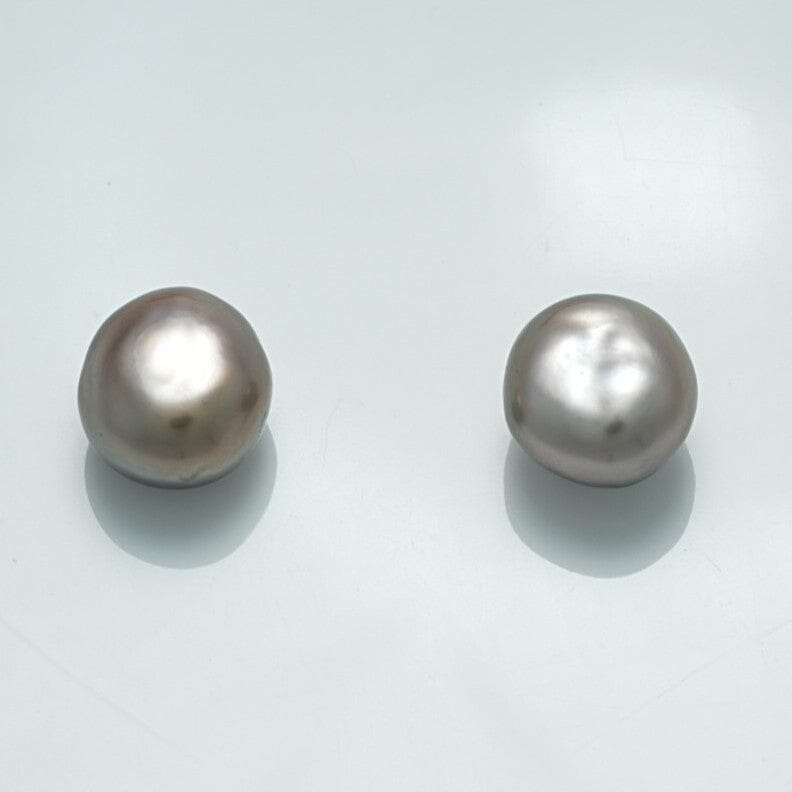 Two lustrous white pearls with irregular shapes reflecting soft light, identified as the 9.9 x 9.1 x 6.9 mm and 10.0 x 9.2 x 7.0 mm Fijian Keshi Pearl Pair.
