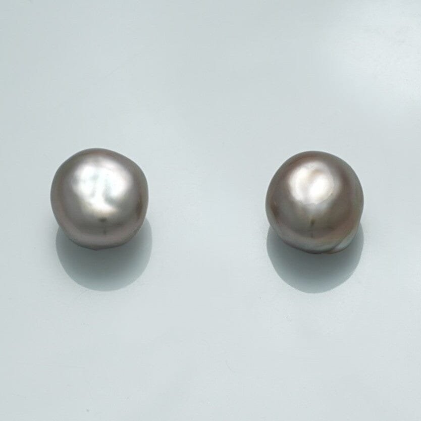 Close-up of 9.9 x 9.1 x 6.9 mm and 10.0 x 9.2 x 7.0 mm Fijian Keshi Pearl Pair showcasing their irregular shapes and soft lustrous surface.