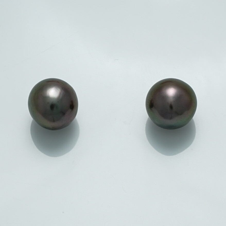 9.8 x 9.6 x 9.2 mm and 19.7 x 9.5 x 9.4 mm Fijian Drop Pearl Pair showcasing dark lustrous black pearls with subtle iridescent overtones on a light background.