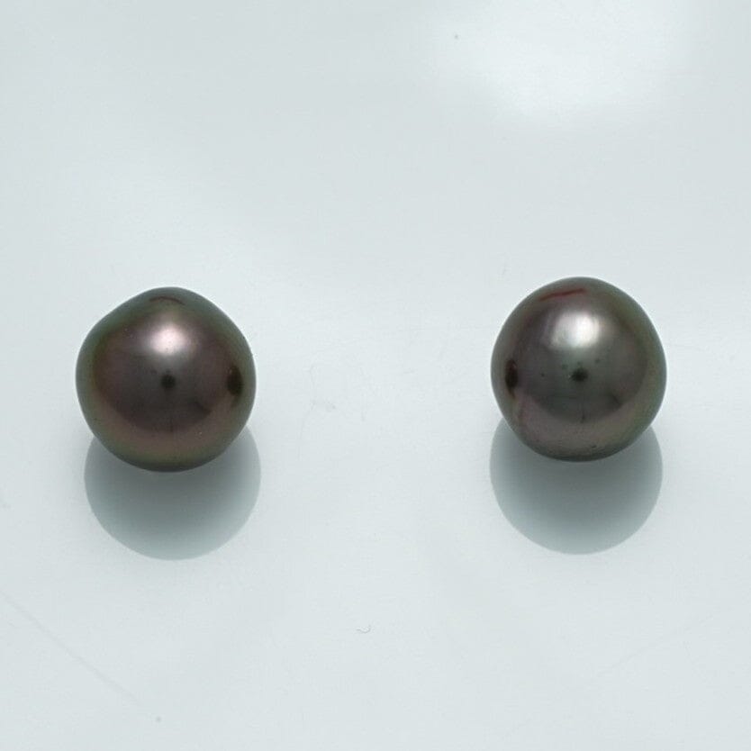 Pair of lustrous dark-colored pearls with smooth surfaces reflecting light, known as 9.8 x 9.6 x 9.2 mm and 19.7 x 9.5 x 9.4 mm Fijian Drop Pearl Pair