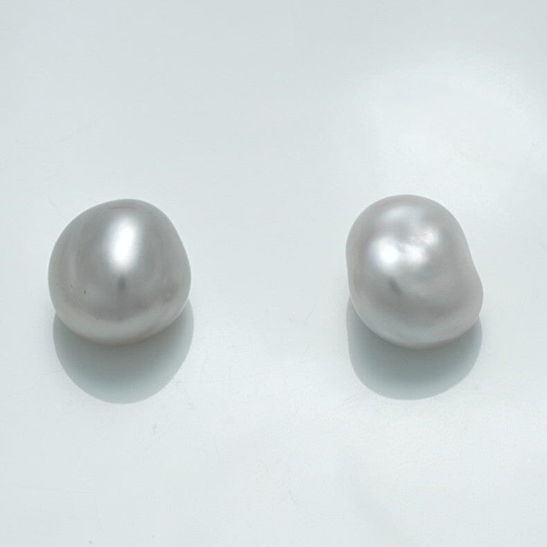 Two lustrous white pearls with irregular shapes on a clean white background, identified as 10.4 x 9.7 x 7.7 mm and 11.0 x 9.6 x 7.2 mm Fijian Keshi Pearl Pair