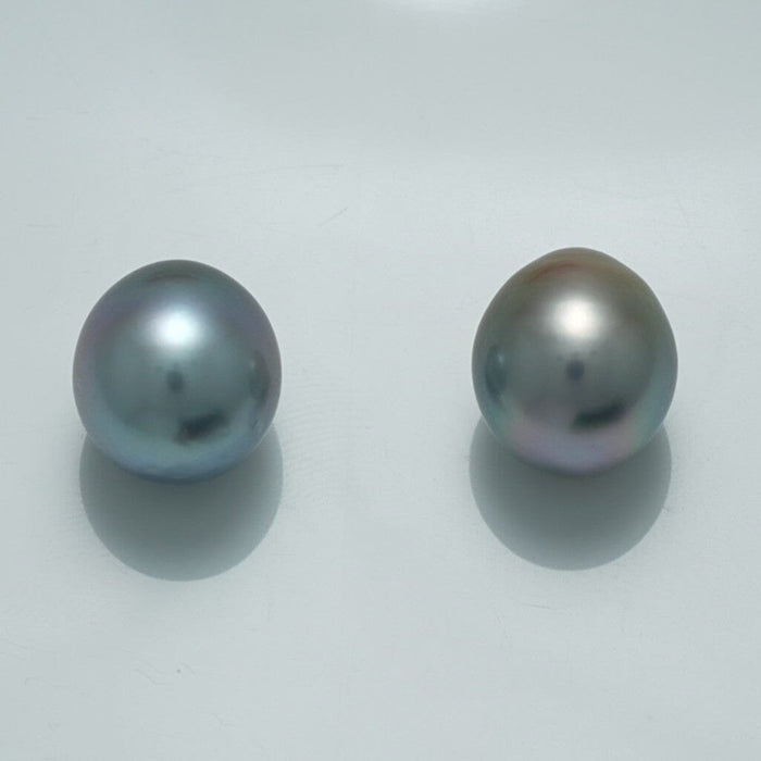 12.1 x 10.9 mm and 12.2 x 10.8 mm Fijian Drop Pearl Pair showcasing two lustrous, smooth drop-shaped pearls with subtle silver and gray hues on a plain light background.