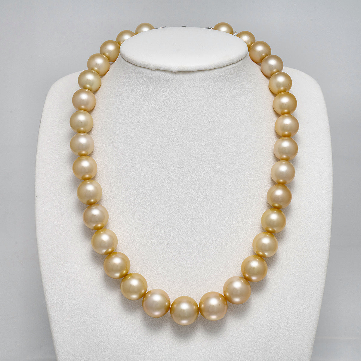12.1-15.1 mm AAA Round Light Golden South Sea Pearl Necklace on a dark background