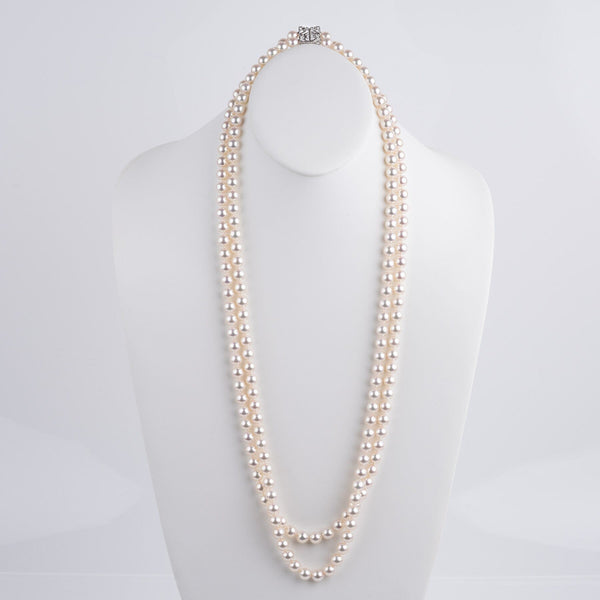 Assael Collection: 9.0–9.5 mm White Akoya Double Strand Necklace, 35 inches displayed on a white bust stand, featuring lustrous cultured white pearls in a classic elegant design.