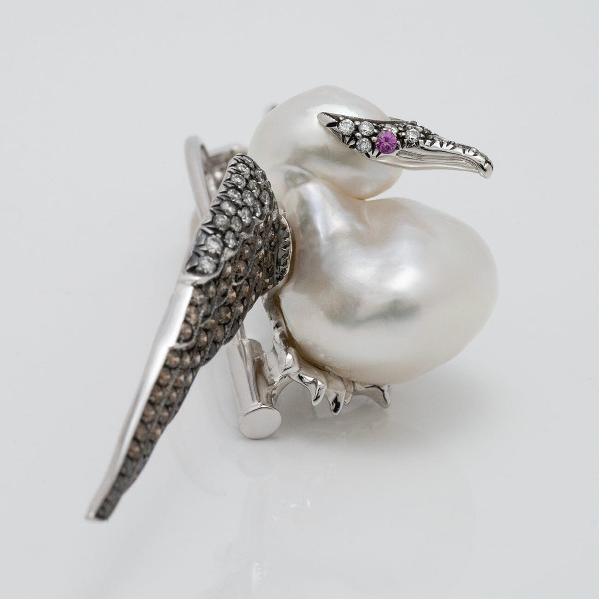 Assael Collection: 14.0 mm White South Sea Pearl, Diamond and Sapphire Brooch designed as a bird with a lustrous pearl body, diamond-studded wings, and a sapphire eye.