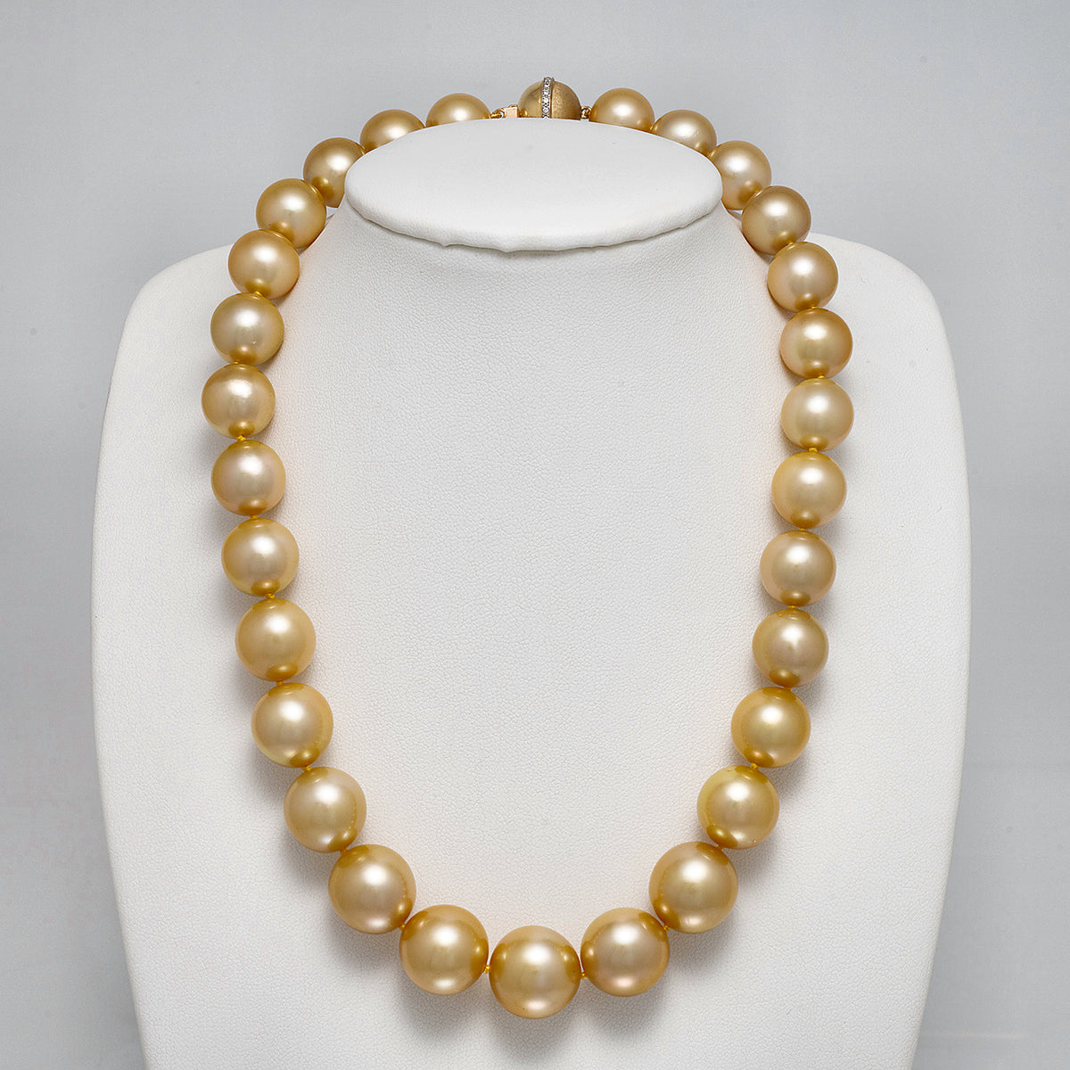 13.0-15.9 mm AAA Round Golden South Sea Pearl Necklace on a dark background