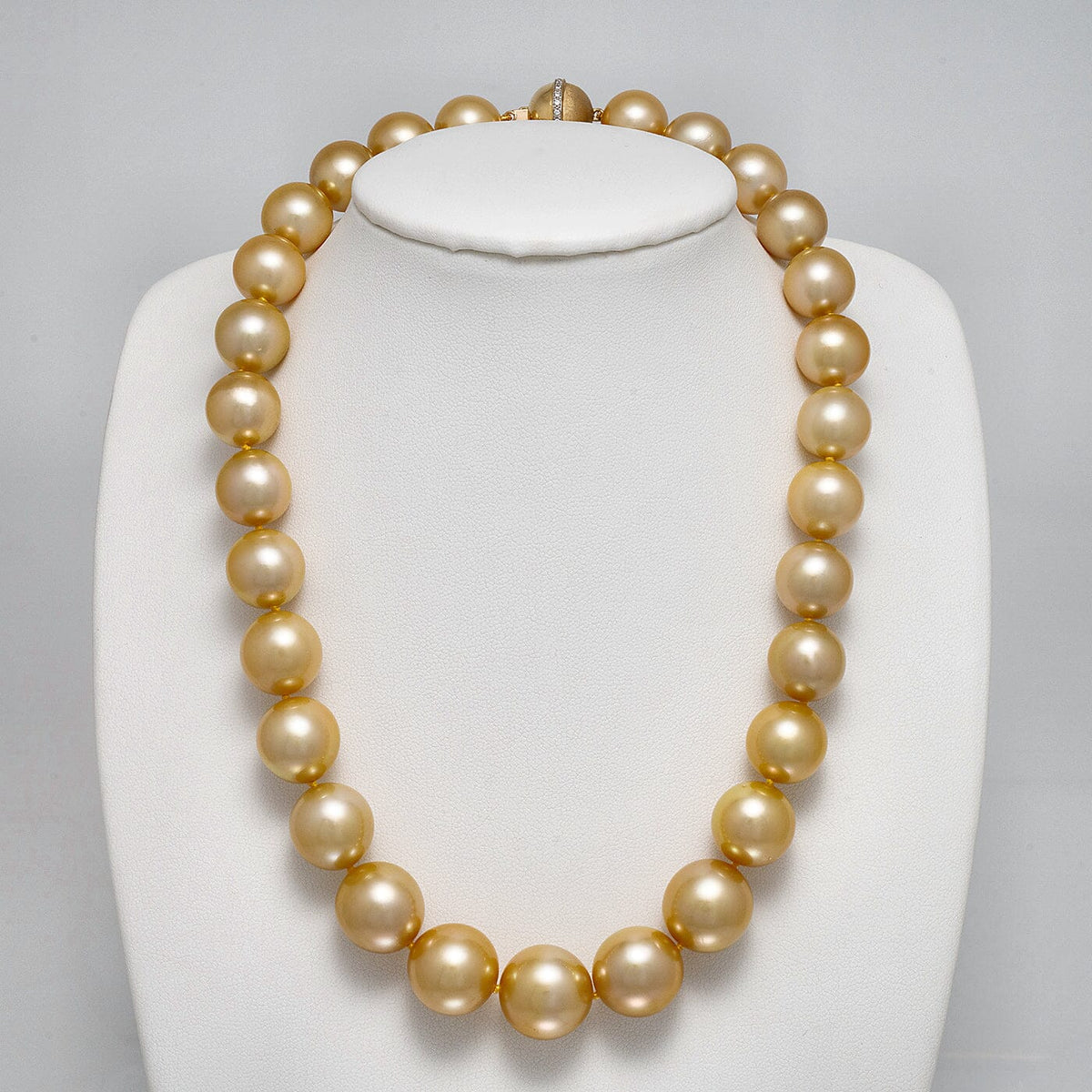 13.0-15.9 mm AAA Round Golden South Sea Pearl Necklace on a dark background