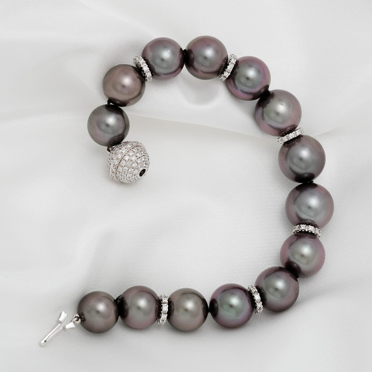 Assael Collection: 10.9–13.1 mm Tahitian Pearl and Diamond Bracelet featuring large, lustrous black pearls accented by sparkling diamond spacers and a pavé diamond clasp.