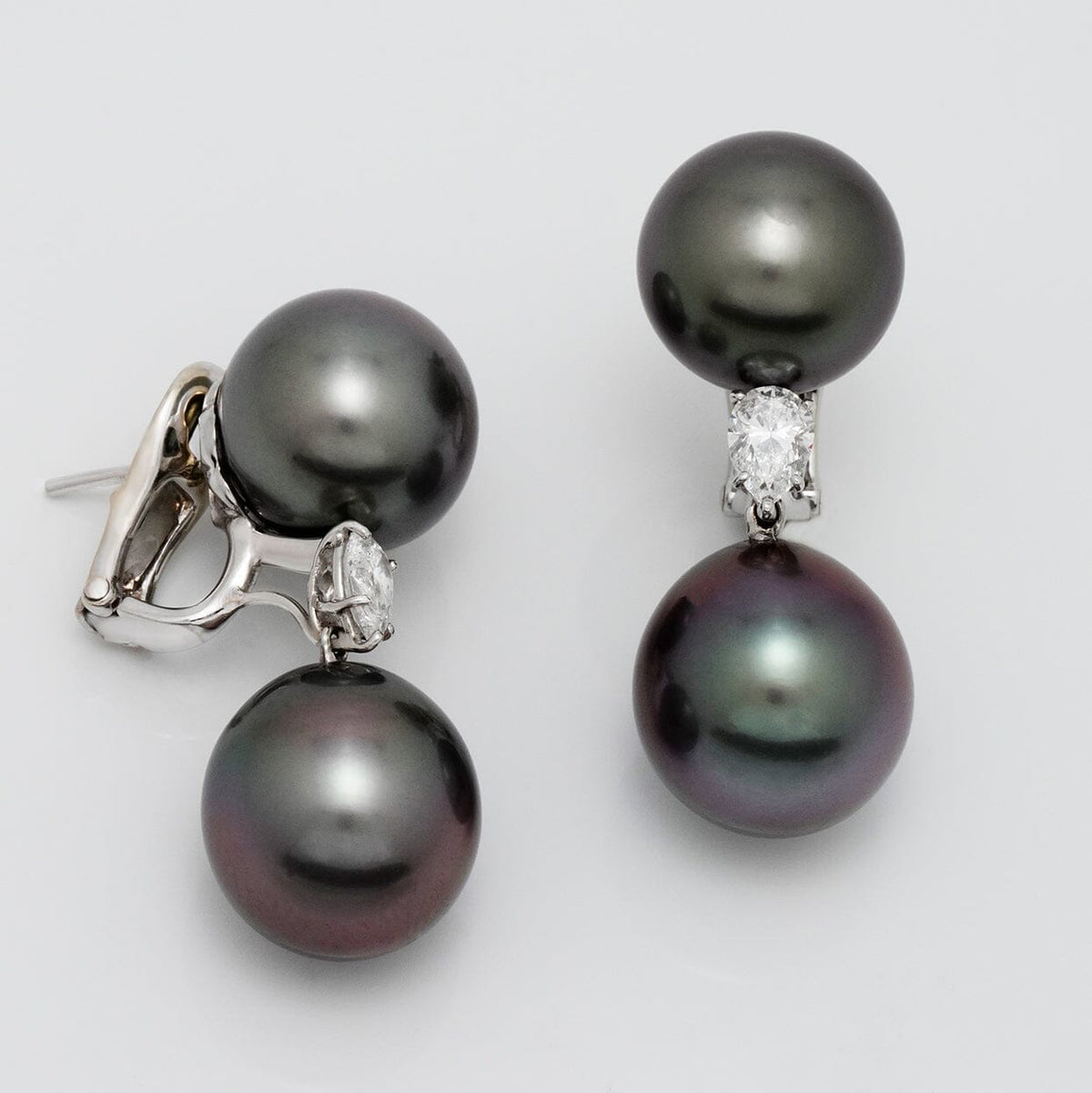 Assael Collection: 12.0–13.0 mm and 13.0–13.0 mm Tahitian Pearl and Diamond Earrings featuring large dark Tahitian pearls accented with sparkling diamonds on a platinum setting.