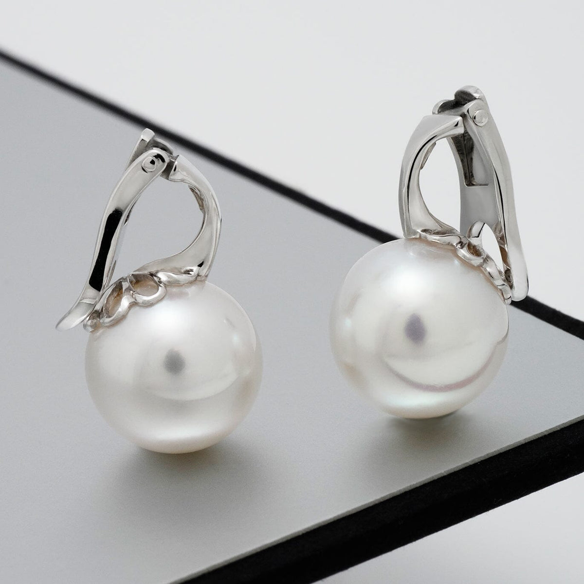 Assael Collection: 11.9 mm South Sea Pearl Earrings featuring lustrous white South Sea pearls set in elegant polished 14K white gold clasps, showcasing timeless sophistication and fine craftsmanship.