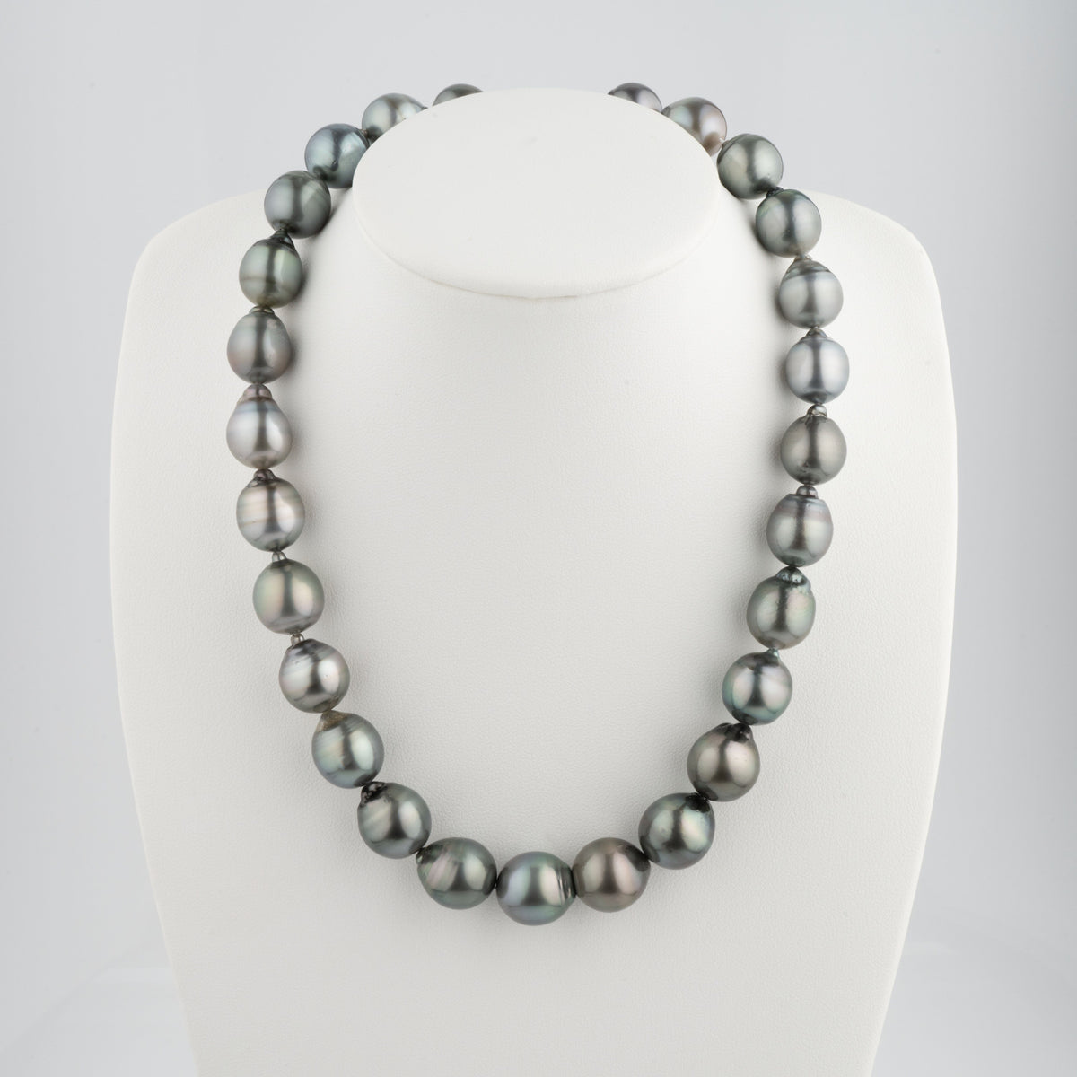 12.1-14.0 mm AA+/AAA Baroque Tahitian Pearl Necklace displayed on a white stand, featuring lustrous, irregularly shaped dark Tahitian pearls with subtle metallic overtones.