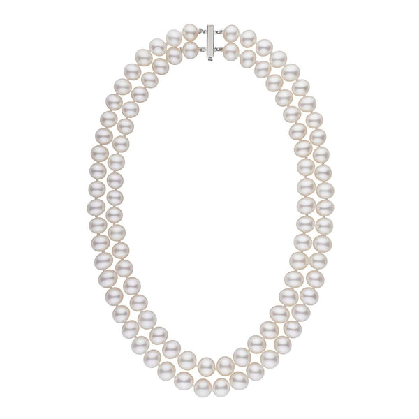 A double strand of white freshwater pearls with a gold clasp, knotted and displayed against a white background.