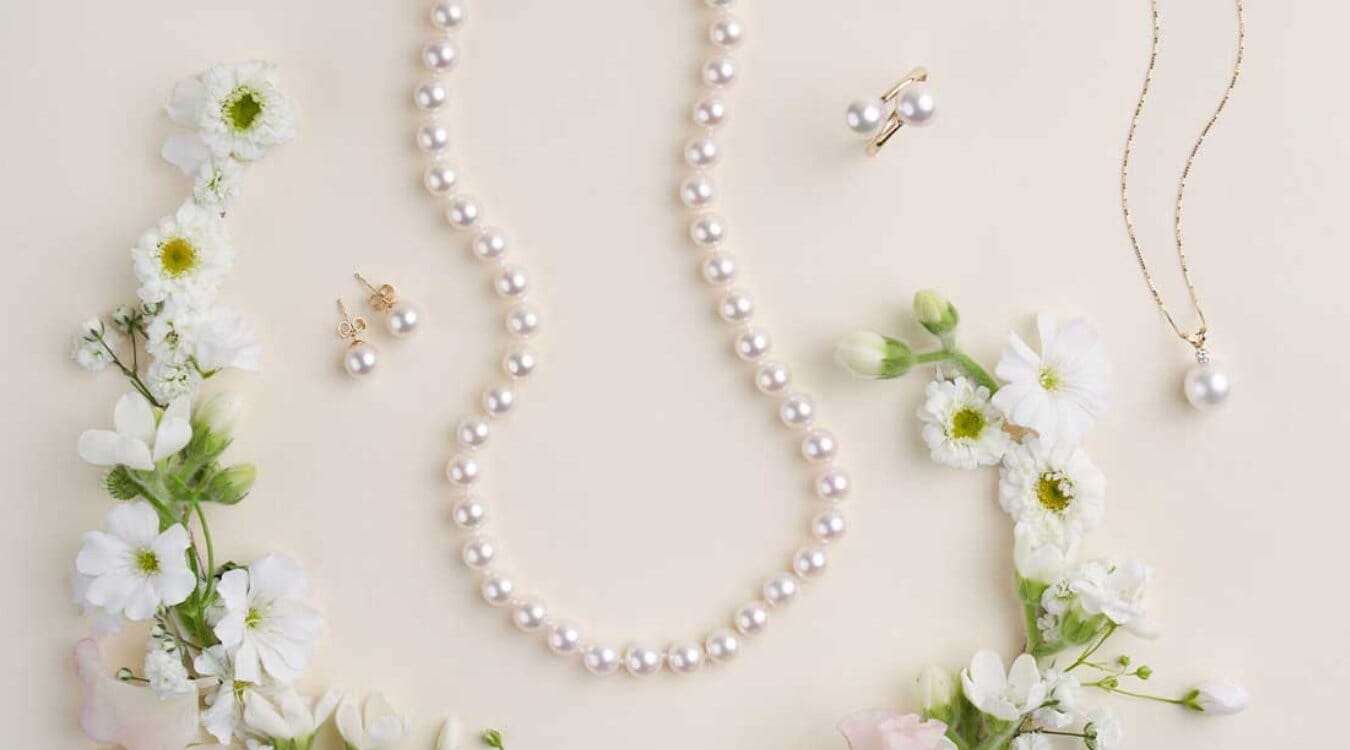 Image of pearl necklace, studs, ring, and pendant with flowers