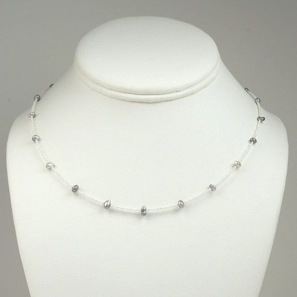 BF-1: Akoya and Tahitian Keshi Pearl Necklace, 18.75" Adj, SS featuring delicate white and dark pearls spaced on a fine 14K white gold chain, showcased on a white display bust.