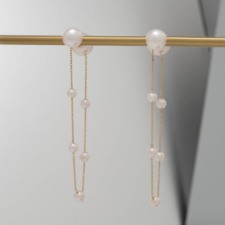 Takahashi: 3.0-7.0 mm Akoya Pearl Earrings featuring delicate gold chains with multiple lustrous white Akoya pearls, elegantly designed for a sophisticated look.
