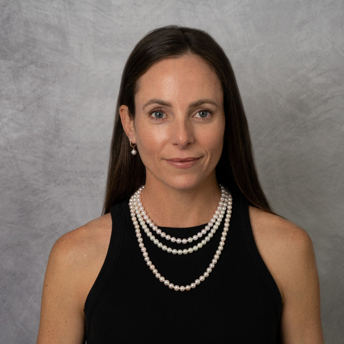 Model wearing a 16-, 18- and 22-inch strand of 7.5-8.0 mm white Akoya pearls