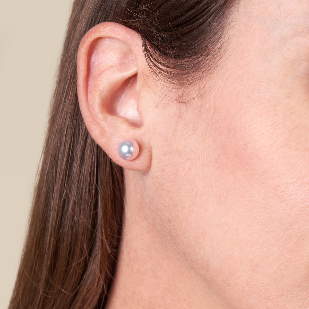 Model wearing a pair of 8-8.5 mm Japanese hanadama certified akoya pearl earrings