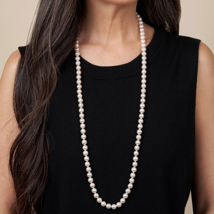 Model wearing an elegant 8.5-9.0 mm 35 Inch AA+ Blush White Silver Rose Tone Akoya Pearl Necklace with lustrous round pearls against a black sleeveless top.