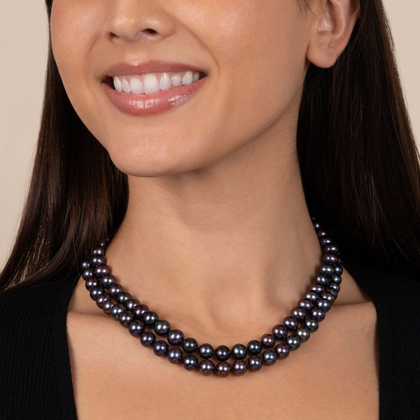 Close-up of a woman wearing a Double Strand 8.5-9.0 mm AAA Black Freshwater Pearl Necklace with deep black and iridescent pearls, styled with a black top.