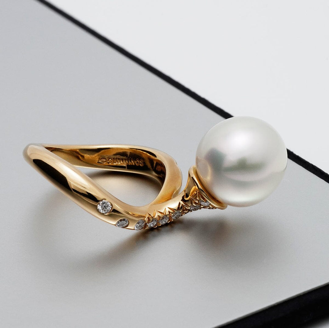 Assael Collection: 11.6 mm White South Sea Pearl and Diamond Ring featuring a lustrous white pearl set on a polished gold band accented with small sparkling diamonds.