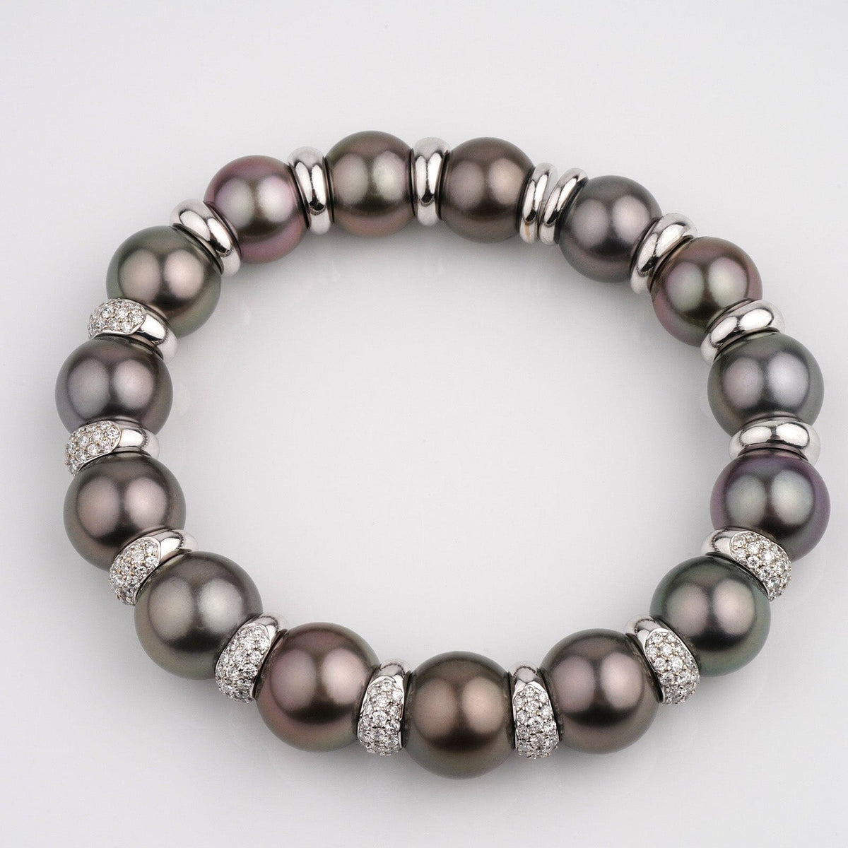 Assael Collection: 11.0-12.7 mm Tahitian Pearl and Diamond Bracelet featuring large dark Tahitian pearls accented by sparkling diamond-studded spacers in an elegant circular design.