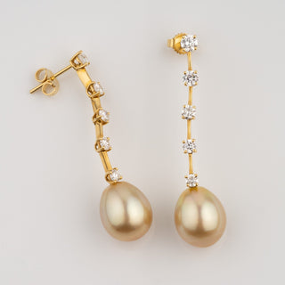 Assael Collection: 11.2 x 13.6 mm Golden South Sea Pearl and Diamond Earrings featuring lustrous golden pearls suspended from elegant gold settings adorned with sparkling diamonds.