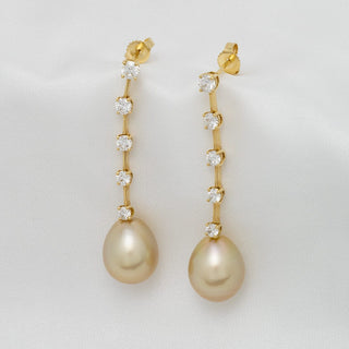Assael Collection: 11.2 x 13.6 mm Golden South Sea Pearl and Diamond Earrings featuring elegant drop pearls with a vertical row of sparkling diamonds set in gold.