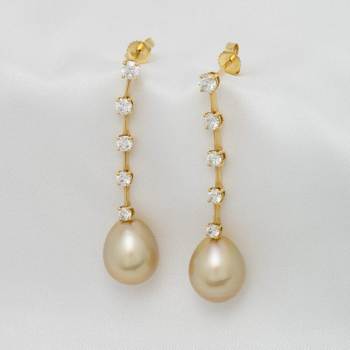 Assael Collection: 11.2 x 13.6 mm Golden South Sea Pearl and Diamond Earrings featuring elegant drop pearls with a vertical row of sparkling diamonds set in gold.