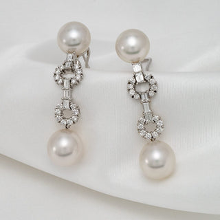 Assael Collection: 10.8-12.7 mm White South Sea Pearl and Diamond Dangle Earrings featuring lustrous white pearls and sparkling diamond accents on a delicate 14K white gold setting.