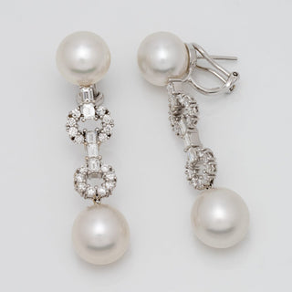 Assael Collection: 10.8-12.7 mm White South Sea Pearl and Diamond Dangle Earrings featuring two lustrous white pearls connected by intricate diamond-set links in a refined drop design.