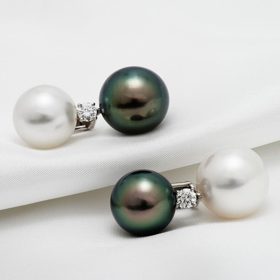 Assael Collection: 13 mm and 14 mm Tahitian & South Sea Pearl and Diamond Earrings featuring one black Tahitian pearl, one white South Sea pearl, and a sparkling diamond accent on each earring.