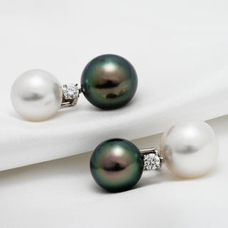 Assael Collection: 13 mm and 14 mm Tahitian & South Sea Pearl and Diamond Earrings featuring one black Tahitian pearl, one white South Sea pearl, and a sparkling diamond accent on each earring.