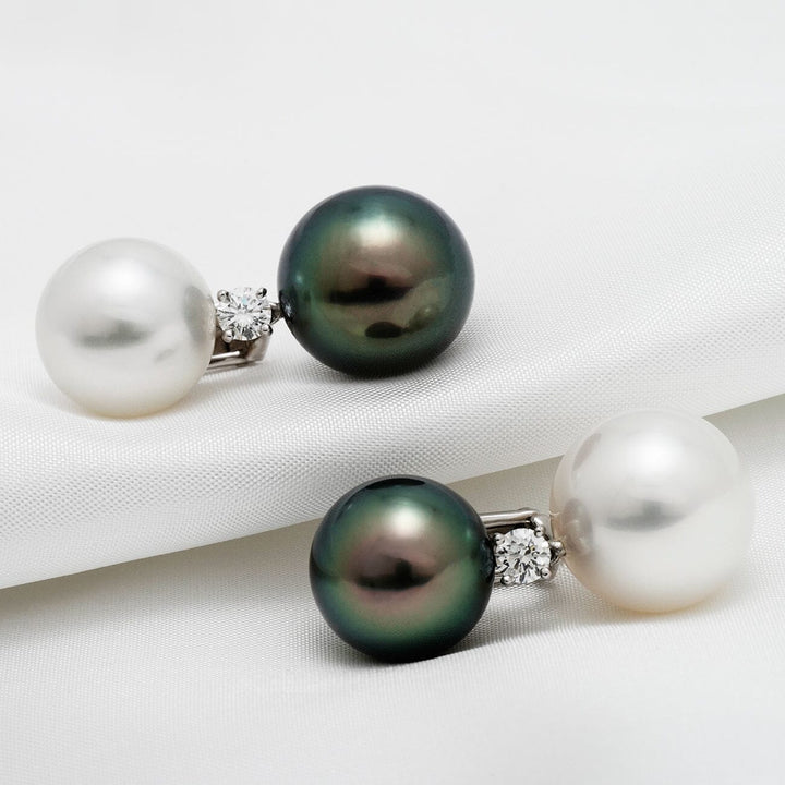Assael Collection: 13 mm and 14 mm Tahitian & South Sea Pearl and Diamond Earrings featuring one black Tahitian pearl, one white South Sea pearl, and a sparkling diamond accent on each earring.
