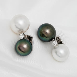 Assael Collection: 13 mm and 14 mm Tahitian & South Sea Pearl and Diamond Earrings featuring classic white and black pearls accented with sparkling diamonds on a 14K white gold setting.