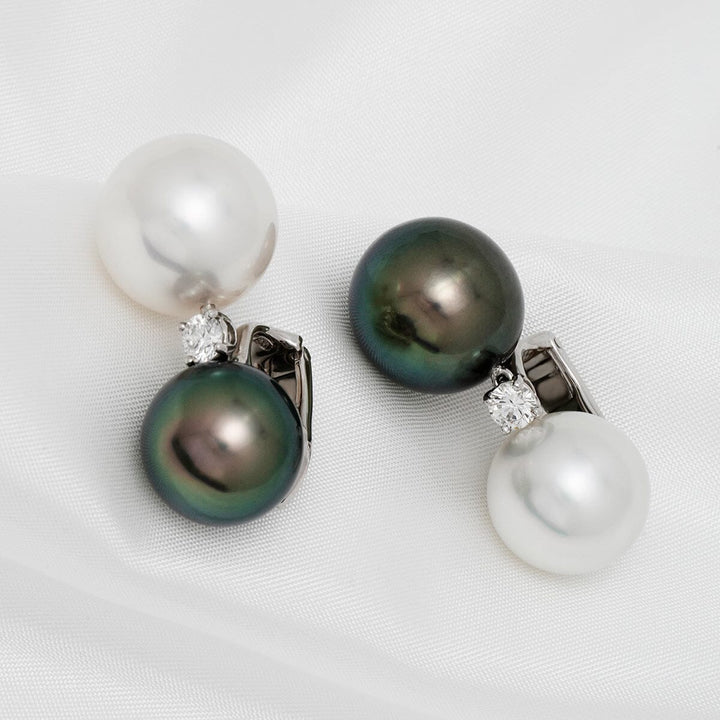 Assael Collection: 13 mm and 14 mm Tahitian & South Sea Pearl and Diamond Earrings featuring classic white and black pearls accented with sparkling diamonds on a silver setting.