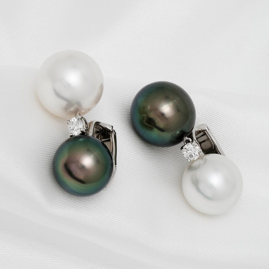 Assael Collection: 13 mm and 14 mm Tahitian & South Sea Pearl and Diamond Earrings featuring classic white and black pearls accented with sparkling diamonds on a 14K white gold setting.