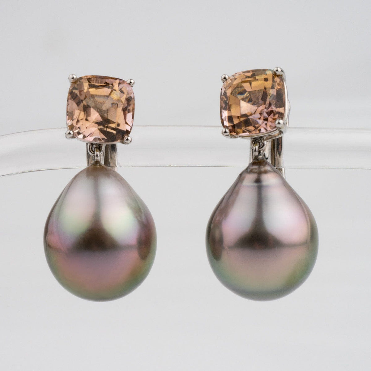 Assael Collection: 16.3x13.0 mm Tahitian Pearl and Tourmaline Earrings featuring large teardrop-shaped Tahitian pearls with cushion-cut light brown tourmaline gemstones in platinum settings.