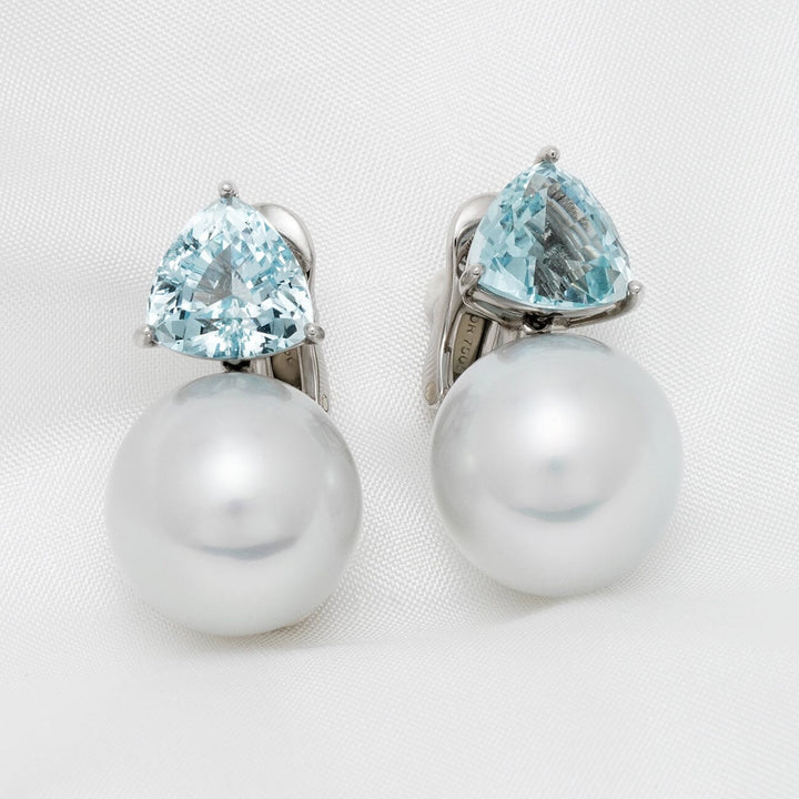 Assael Collection: 15 mm South Sea Pearl and Aquamarine Earrings featuring large white pearls paired with triangular aquamarine gemstones in a polished setting.