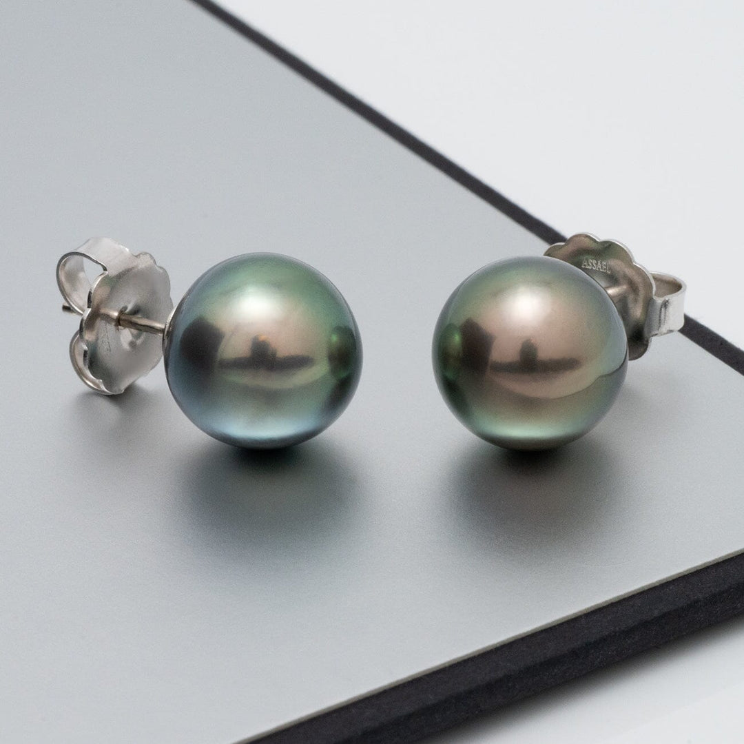 Assael Collection: 12.0–13.0 mm Tahitian Pearl Stud Earrings featuring round cultured pearls with a natural dark green and gray iridescent luster set on silver stud backings.