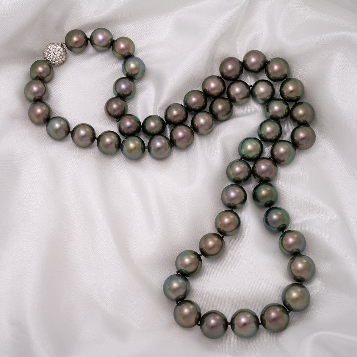 Assael Collection: 15.0–16.9 mm Round Tahitian Pearl and Diamond Necklace, 32.5 inches, featuring lustrous dark Tahitian pearls with a sparkling diamond clasp on a silky white background.