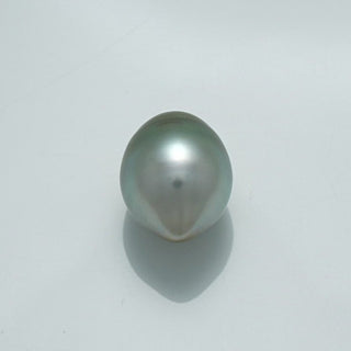 Single lustrous 13.2 x 10.5 mm Fijian Drop Pearl with a smooth, reflective surface and subtle greenish-gray tones casting a soft shadow on a plain background.