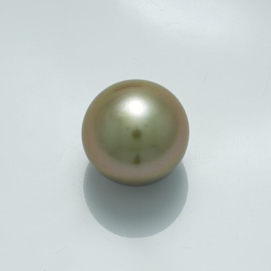 13.5 x 13.4 mm Fijian Pearl displaying a smooth, lustrous surface with subtle green and pink overtones on a light background, reflecting its fine quality and natural beauty.