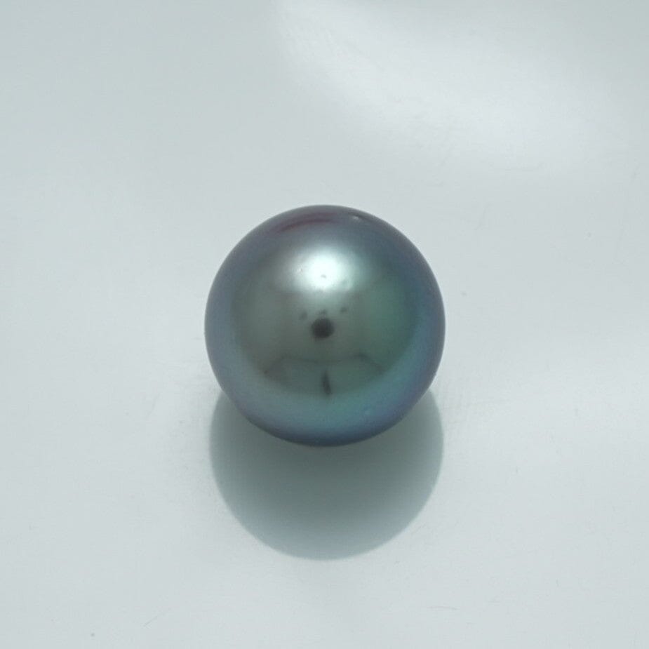 13.3 x 13.3 mm Fijian Pearl with a smooth surface and lustrous dark gray-green hues, reflecting subtle iridescent colors typical of fine cultured pearls.