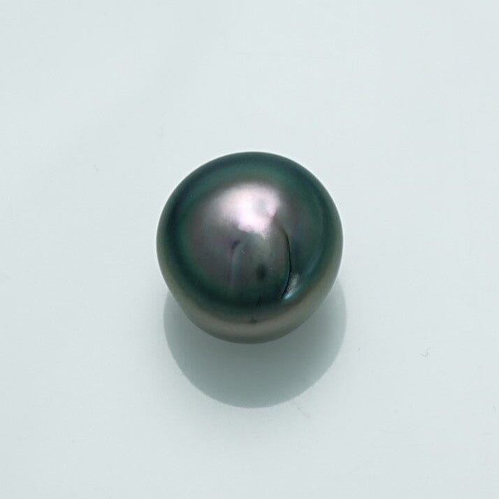 10.5 x 8.8 mm Fijian Keshi Pearl with smooth, lustrous surface displaying deep green and purple overtones against a plain white background.