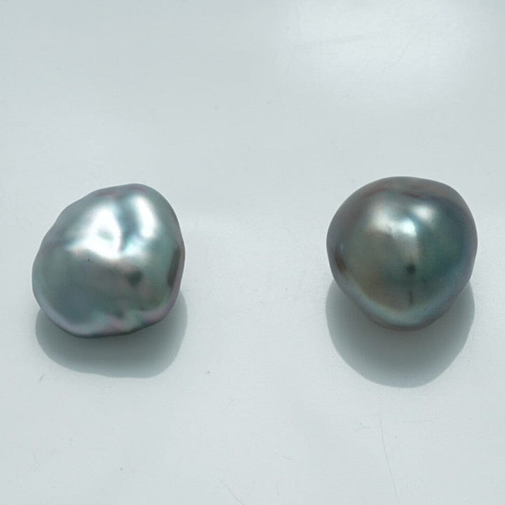 12.5 x 11.2 mm and 12.0 x 11.1 mm Fijian Keshi Pearl Pair showcasing natural baroque shapes with a lustrous, metallic gray finish and subtle iridescent hues.