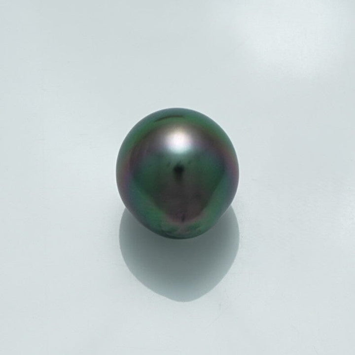 13.5 x 12.2 mm Fijian Drop Pearl showcasing a lustrous deep dark green and subtle iridescent hues, reflecting light gently on a clean white background.